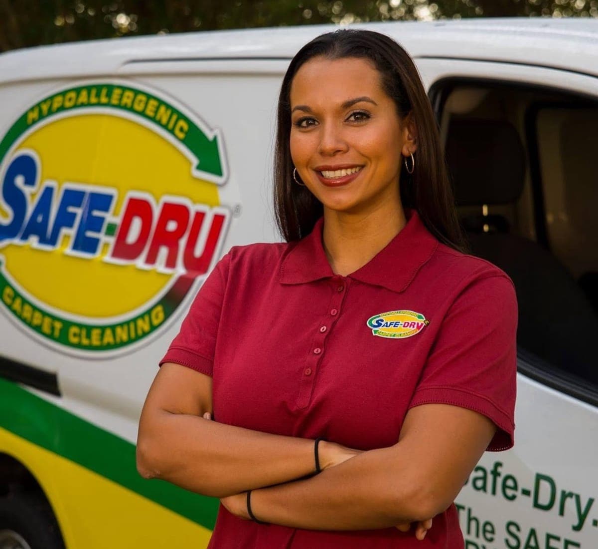 Safe-Dry team member standing in front of a branded service van