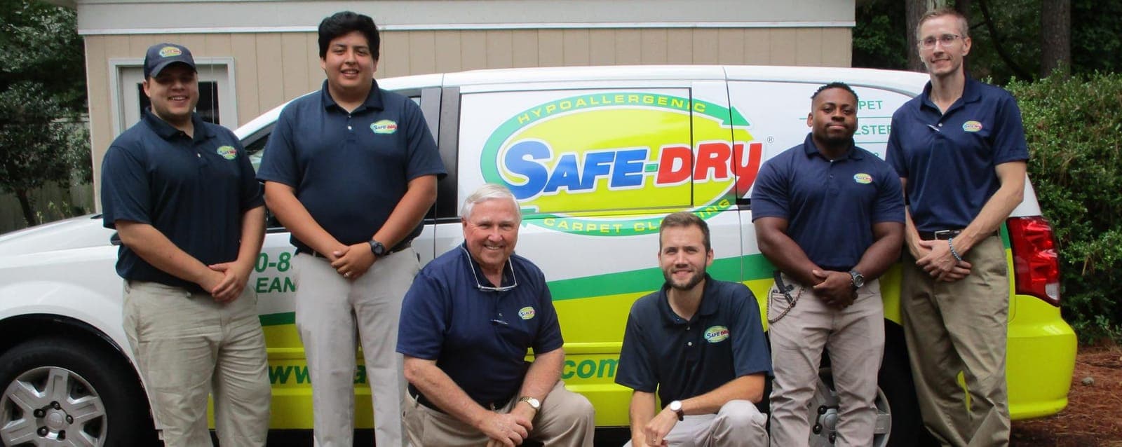 Safe-Dry crew standing in front of a branded service van