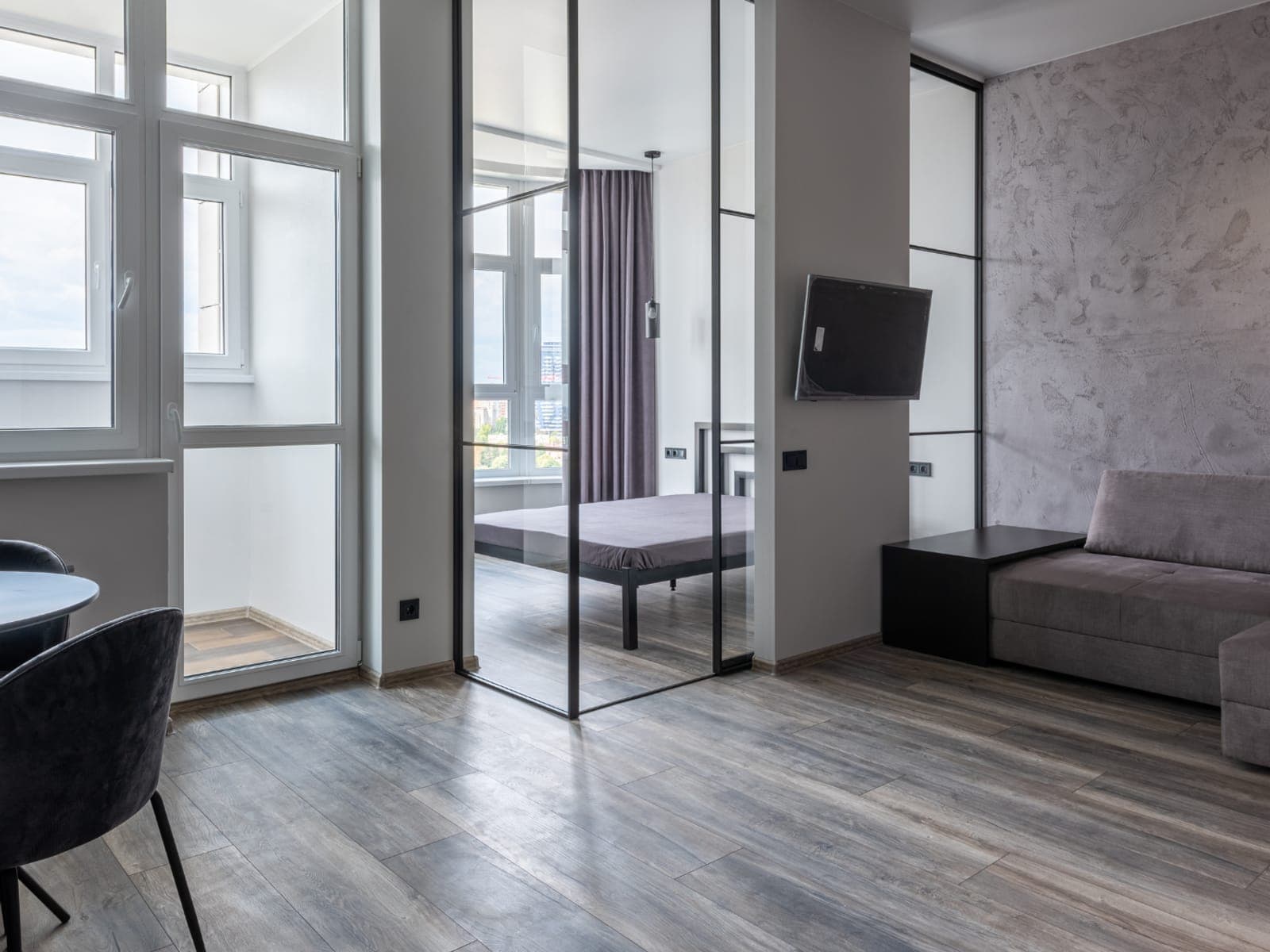 Gray vinyl plank flooring running through a modern apartment